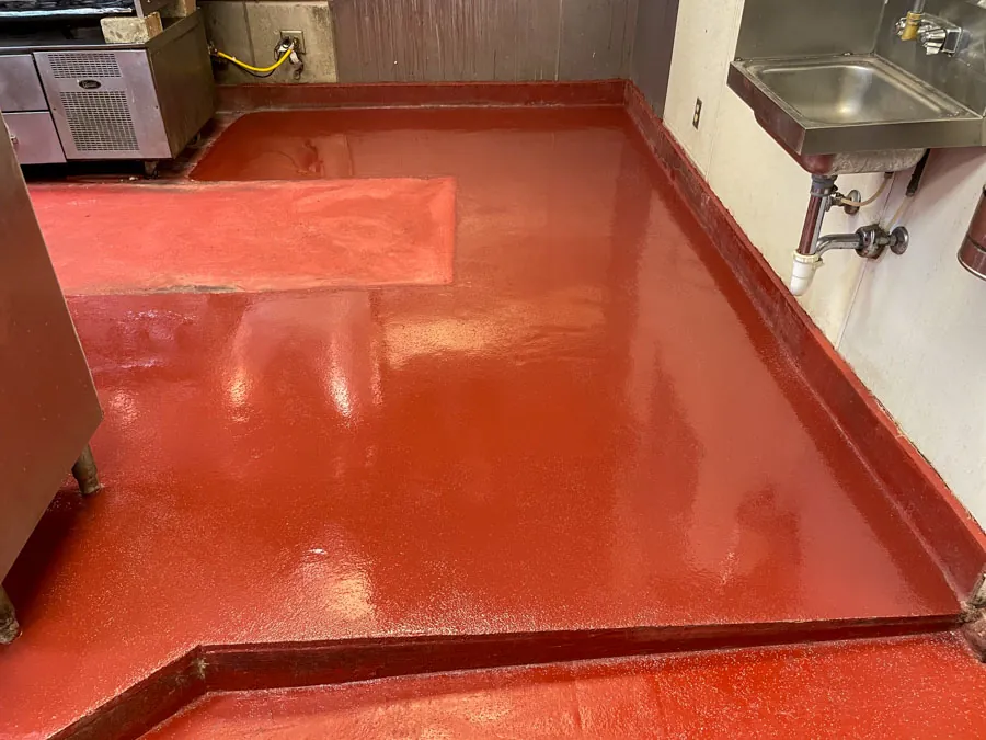 Red epoxy floor in a commercial prep area, concrete coating serving Nashville, TN