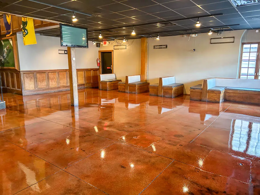 Glossy red stained concrete sports bar floor, commercial epoxy flooring serving Nashville, TN